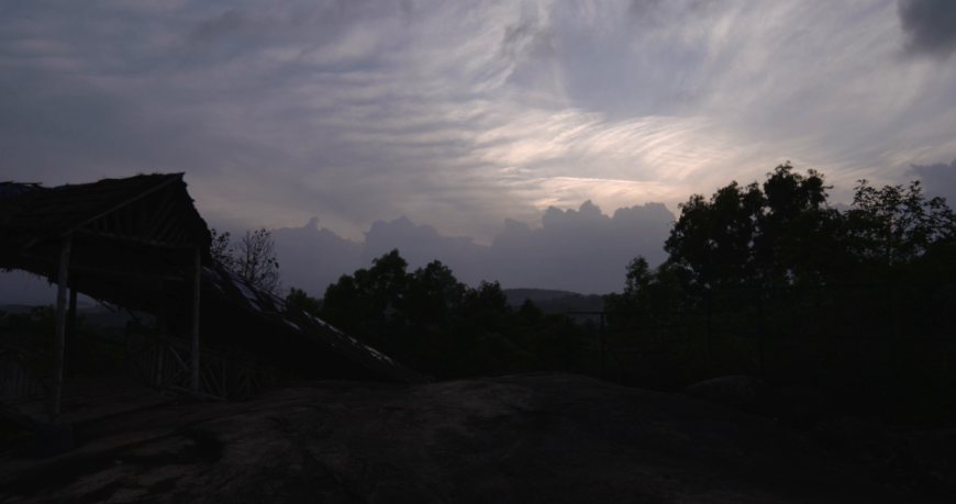 Moving clouds with a hut in the foreground