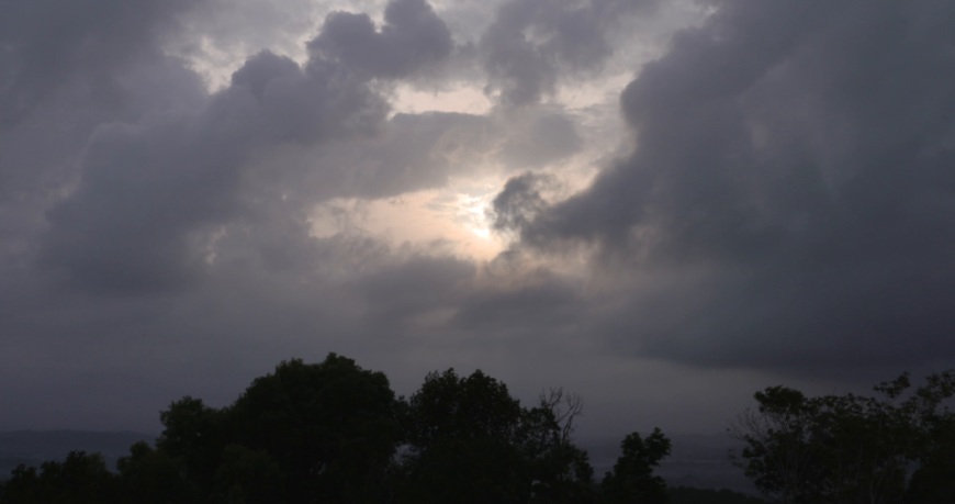 Dark clouds moving towards horizon