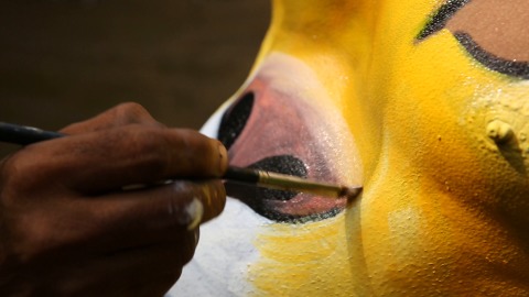 Close-up shot of Pulikali (Tiger Dance) makeup