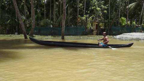 Man rowing through flood-affected areas during Kerala Floods 2018