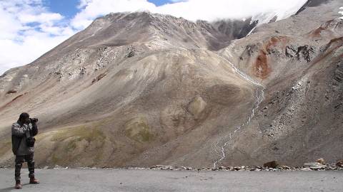 Biker photographing the Himalayan mountains, India