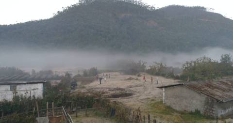 People exploring fog covered Munnar landscape