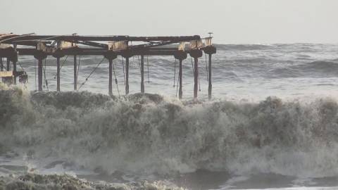 Sea waves hitting the broken sea bridge at Alappuzha beach