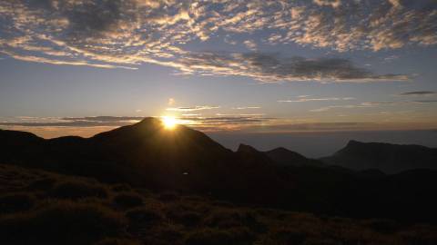 Sun peeping through mountain ranges